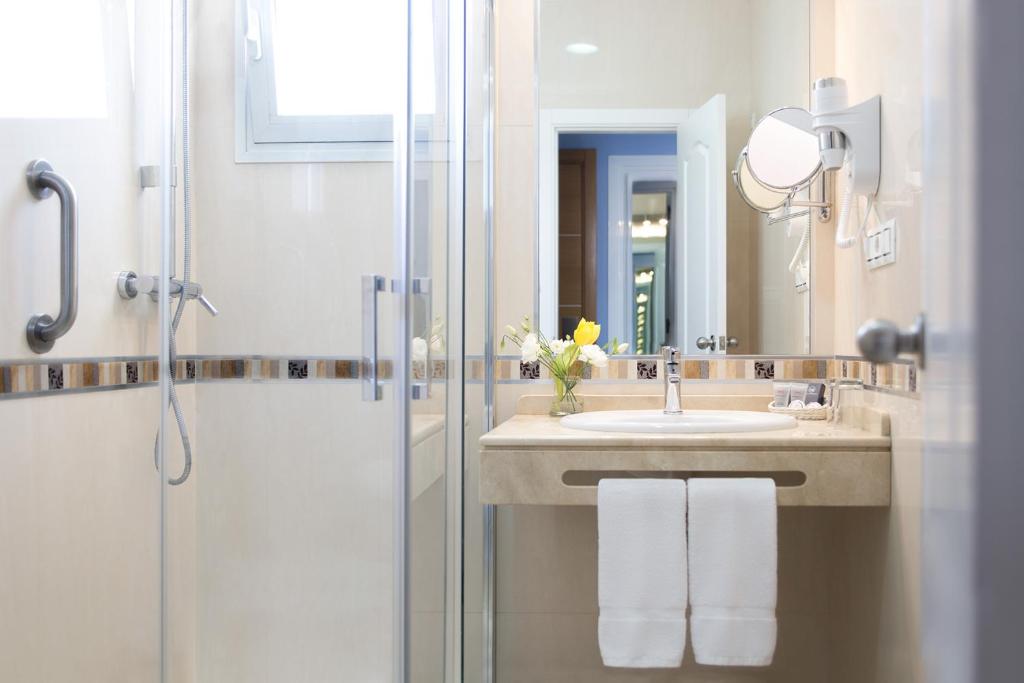 a bathroom with a sink and a shower at Hotel Plaza Cavana in Nerja