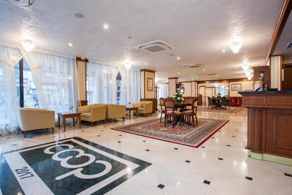 a lobby with a table and chairs in a building at Hotel COOP, Sofia in Sofia