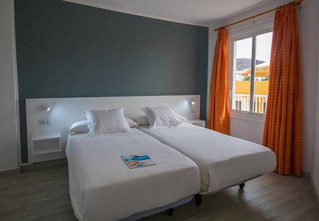 Postel nebo postele na pokoji v ubytování Checkin Bungalows Atlántida