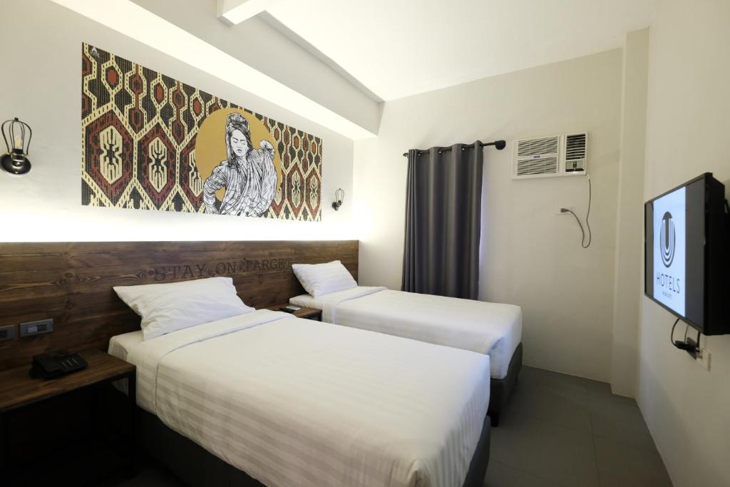 Postel nebo postele na pokoji v ubytování U Hotels Makati