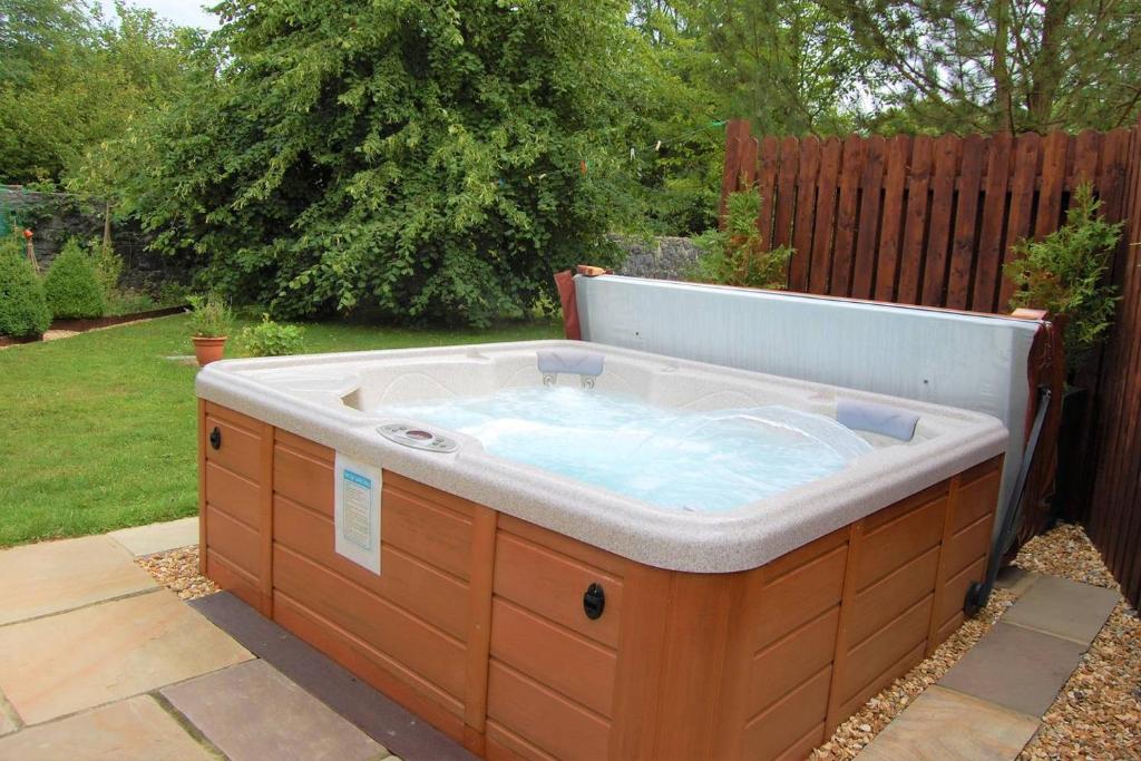 a hot tub in the backyard of a yard at Rosewood Cottage in Galway