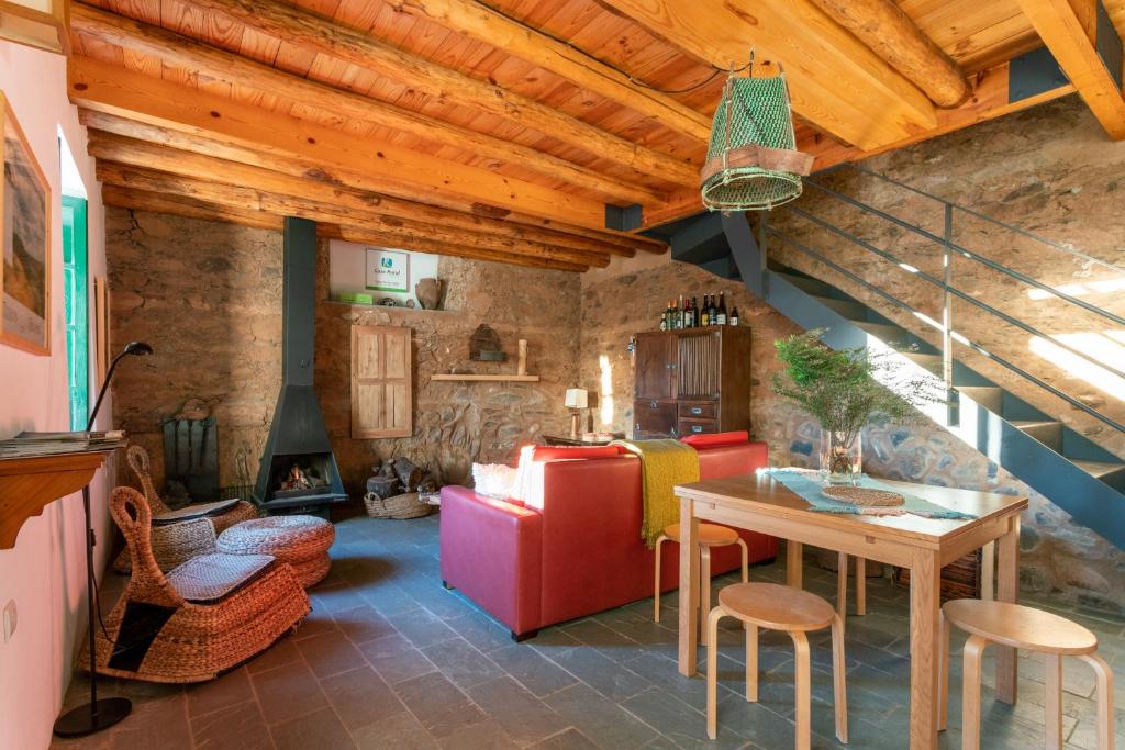uma cozinha e sala de estar com mesa e cadeiras em Casa de los Curas, chimenea 2 Hab 4 Pers Max em Puerto de la Laja