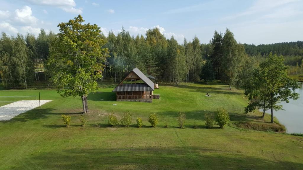 an aerial view of a cabin in the middle of a field at Leimaņi in Vaidava