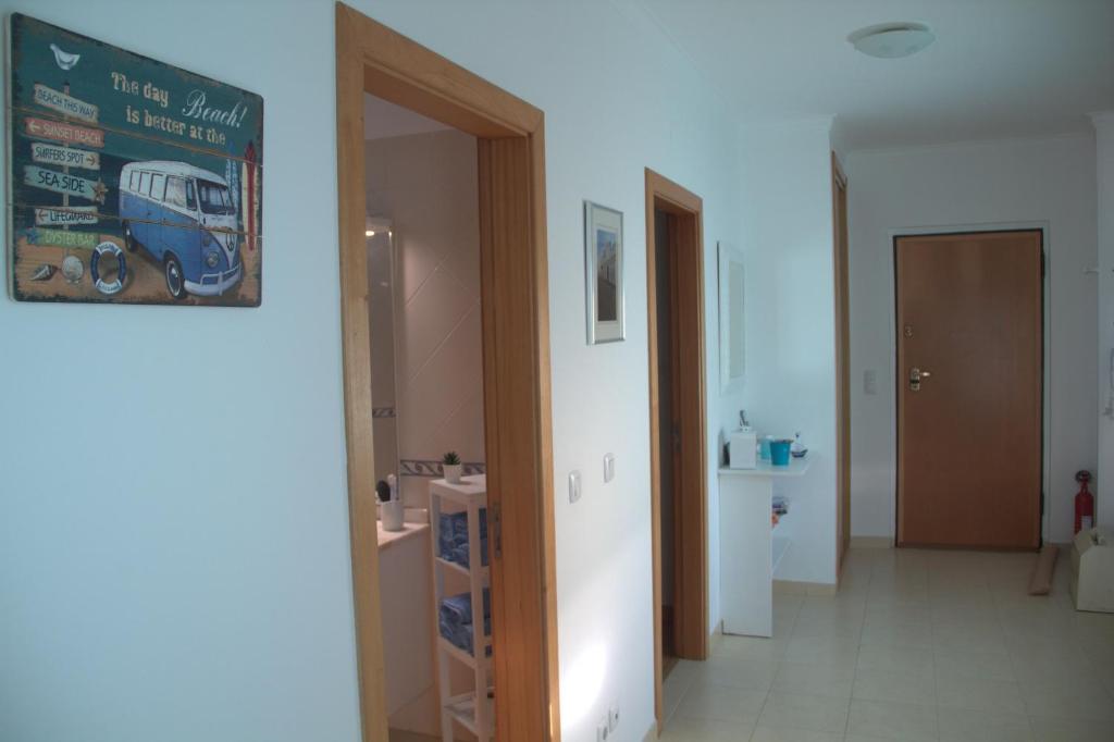 a hallway withthis study is needed sign on the wall at Ericeira Sunset Apartment in Ericeira