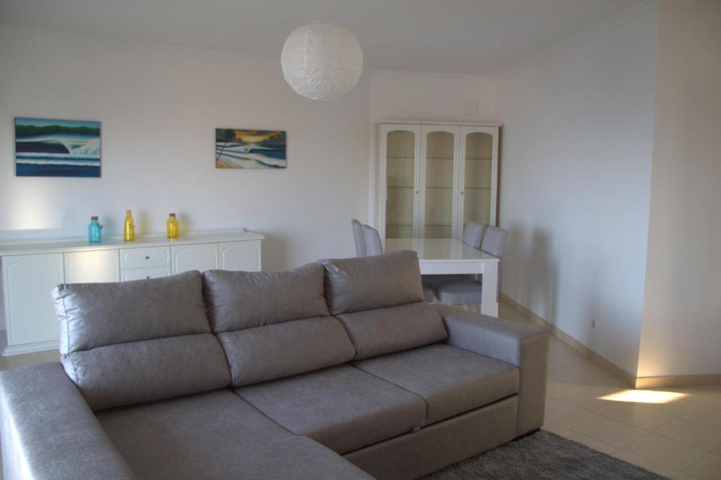 a living room with a couch and a table at Ericeira Sunset Apartment in Ericeira