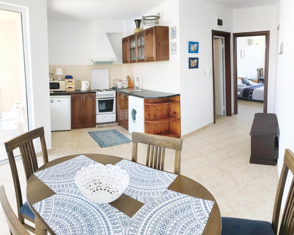 a kitchen and dining room with a table and chairs at Apartament Rose in Sozopol