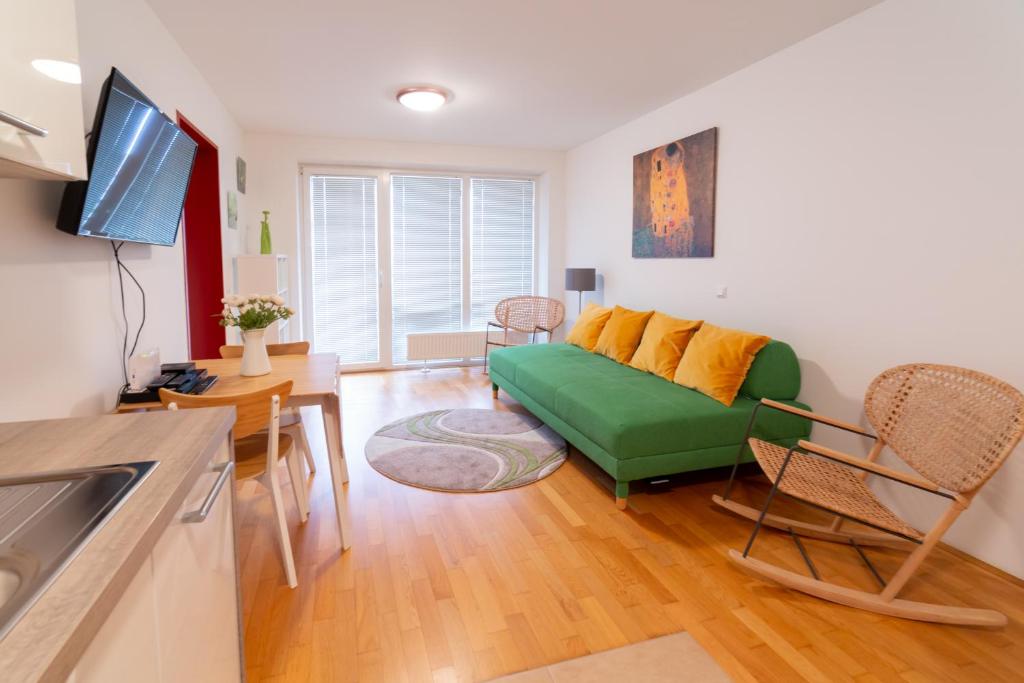 a living room with a green couch and a table at A Twist of Lime in Moravske-Toplice