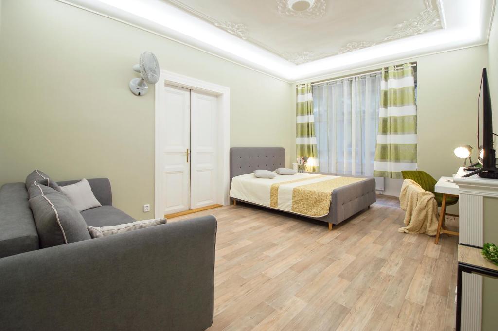 a living room with a bed and a couch at Modern Apartment Navratilova 16 in Prague