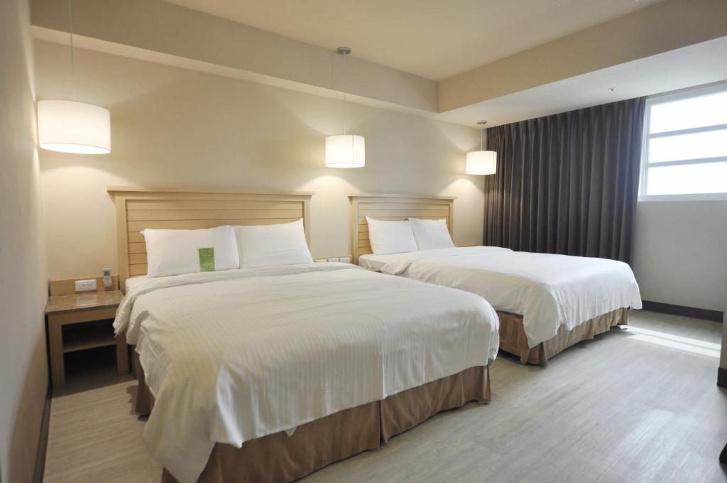 Ліжко або ліжка в номері Kindness Hotel-Qixian