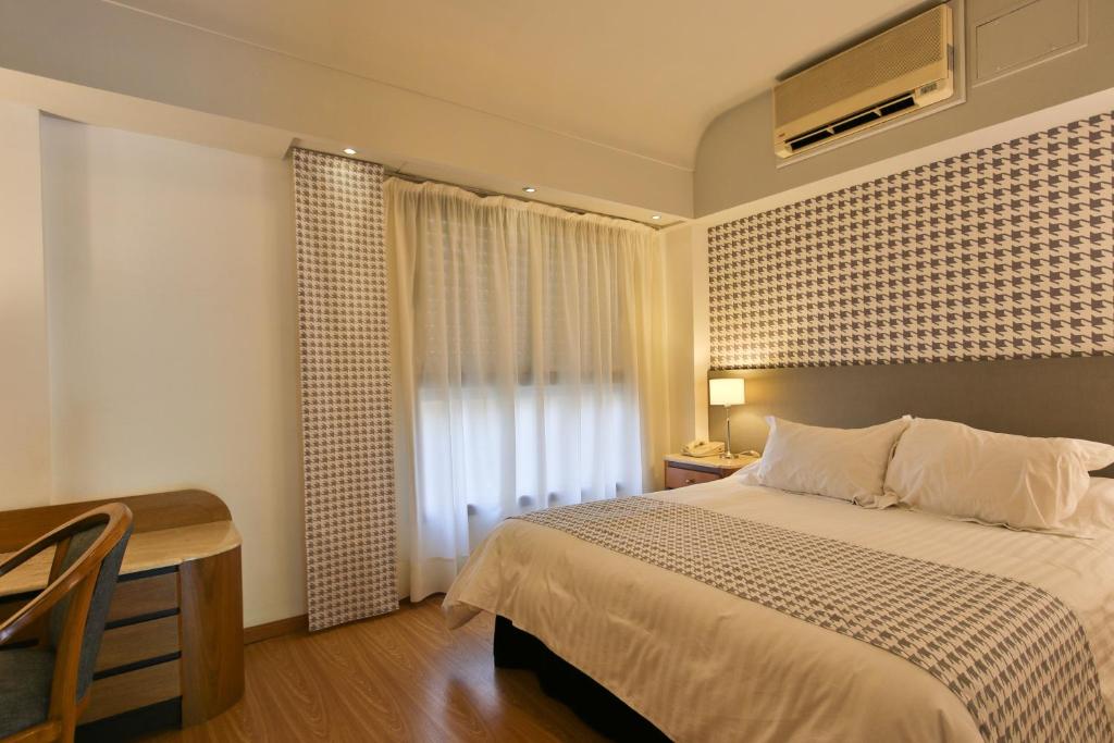 Postel nebo postele na pokoji v ubytování Gran Hotel Parana