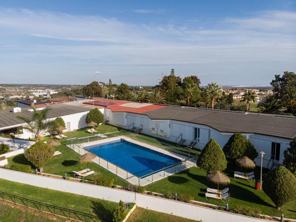 an aerial view of a house with a swimming pool at Parador de Ayamonte in Ayamonte