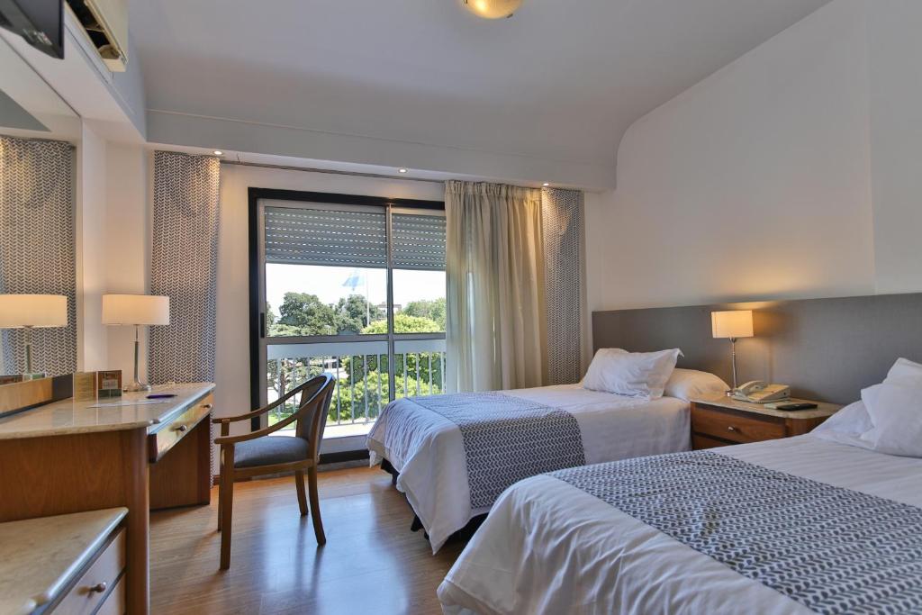Postel nebo postele na pokoji v ubytování Gran Hotel Parana