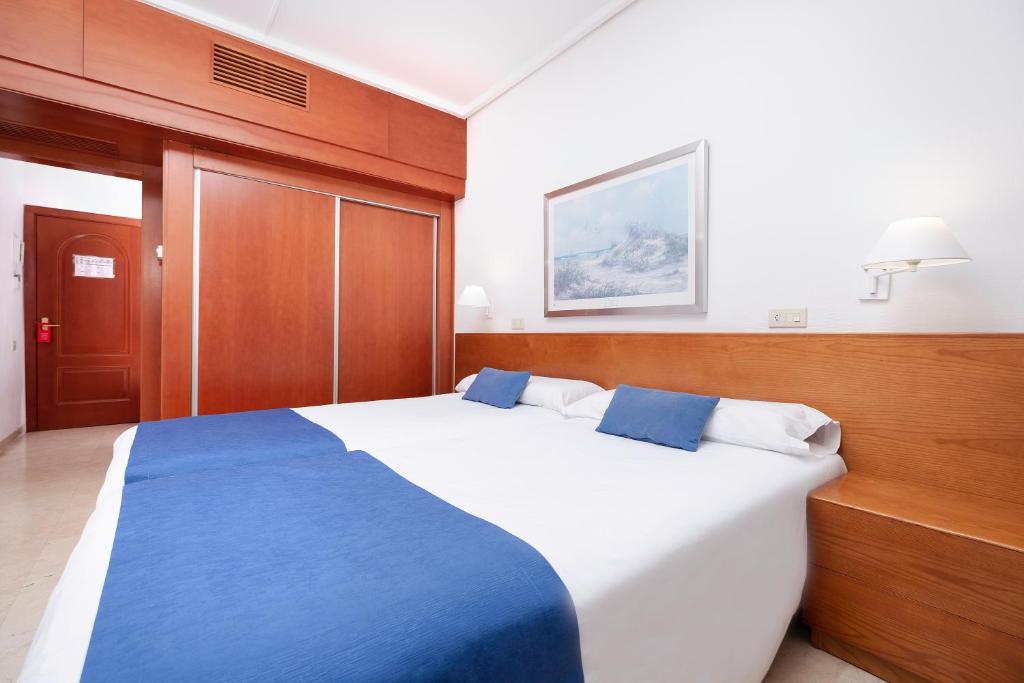 Postel nebo postele na pokoji v ubytování Hotel Concorde
