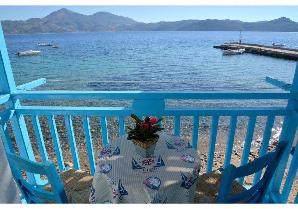 a table and two chairs on a balcony overlooking the water at On the Waves of Klima in Klima