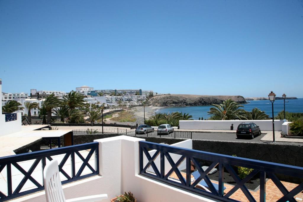 a view of the water from a balcony of a building at Casa Coloradas in Playa Blanca