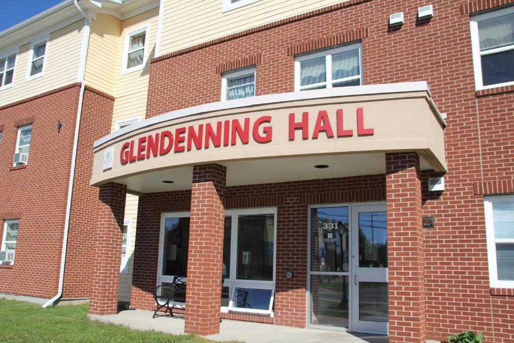 un edificio de ladrillo con una señal para un salón de limpieza en Glendenning Hall at Holland College, en Charlottetown