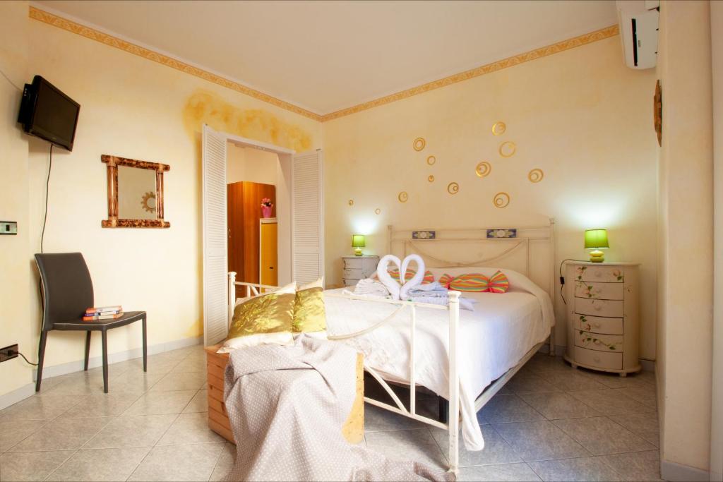 - une chambre avec un lit blanc et une commode dans l'établissement B&B Lety, à Alghero
