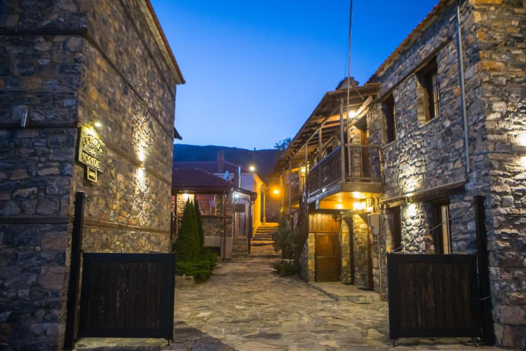 an alley in an old building at night at Nostos in Palaios Agios Athanasios