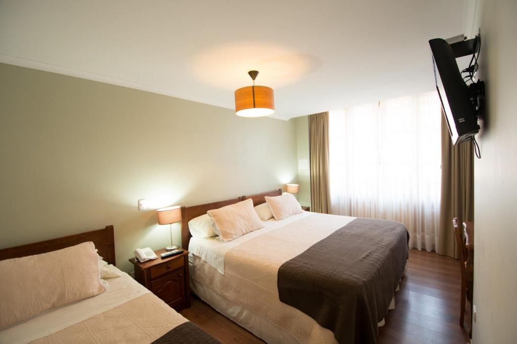 Postel nebo postele na pokoji v ubytování Hotel Loreto