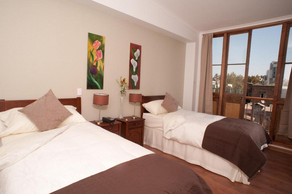 Postel nebo postele na pokoji v ubytování Hotel Loreto