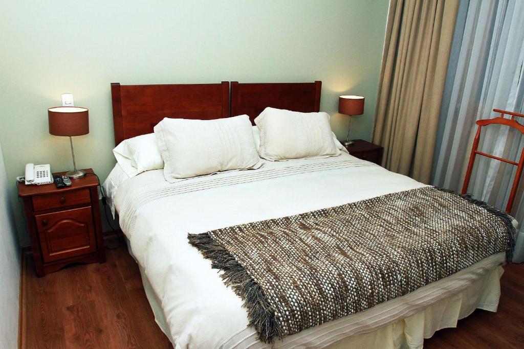Postel nebo postele na pokoji v ubytování Hotel Loreto