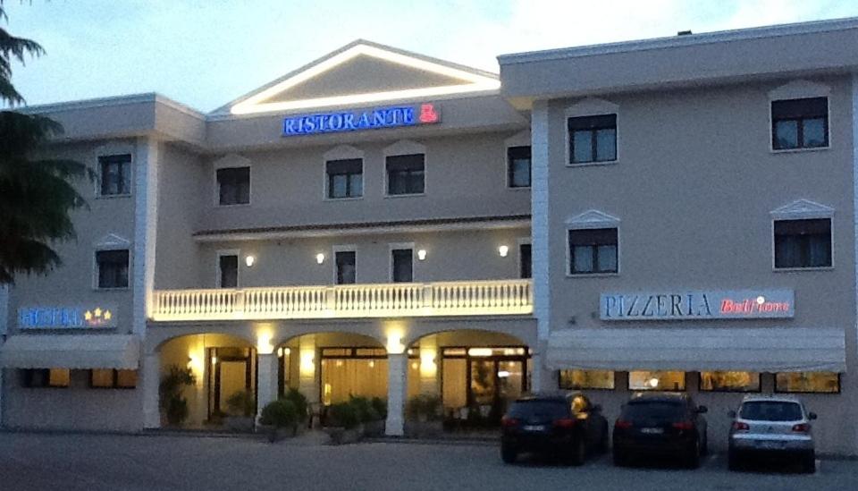 a hotel with two cars parked in front of it at Hotel Belfiore in Salzano