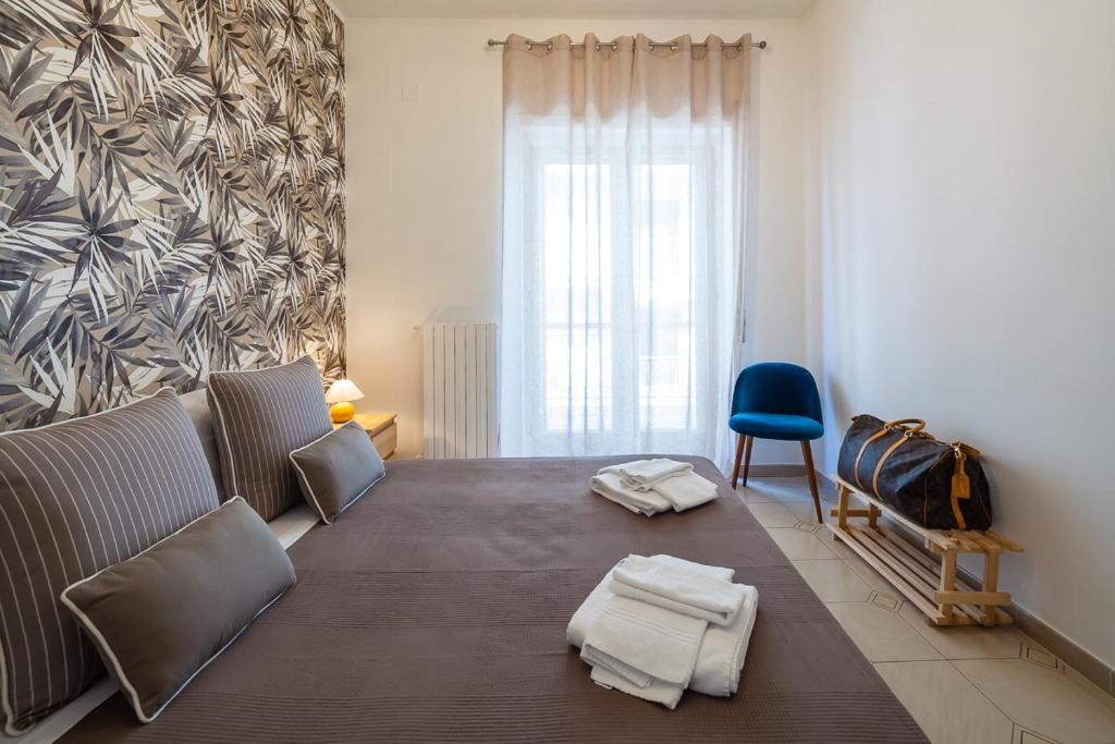 a living room with a couch and a blue chair at Aranci 99 House in Sorrento