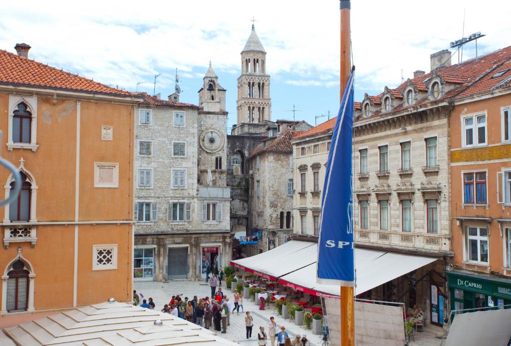 a street in a city with a blue flag at Luxury Rooms Lucija and Luka in Split