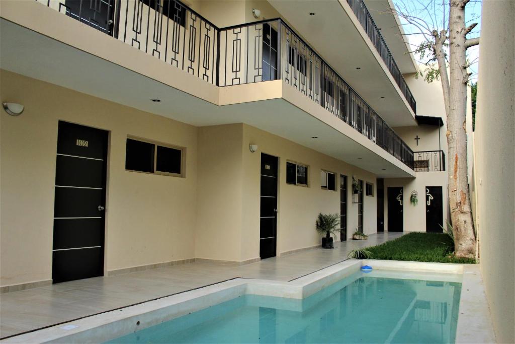 a house with a swimming pool in front of it at Hotel Virreyes in Mérida