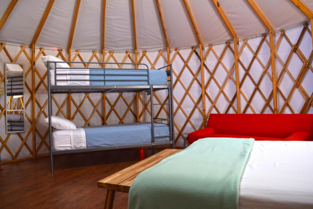 a room with two bunk beds in a yurt at Yosemite RV Resort in Coarsegold