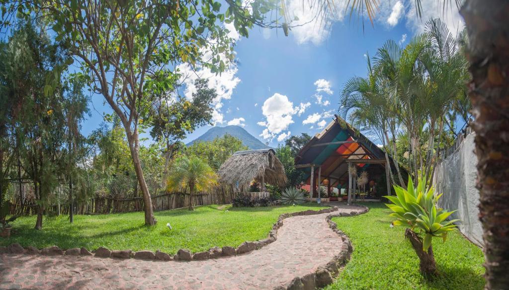 a garden with a house and a path at Zoola San Pedro Atitlan in San Pedro La Laguna