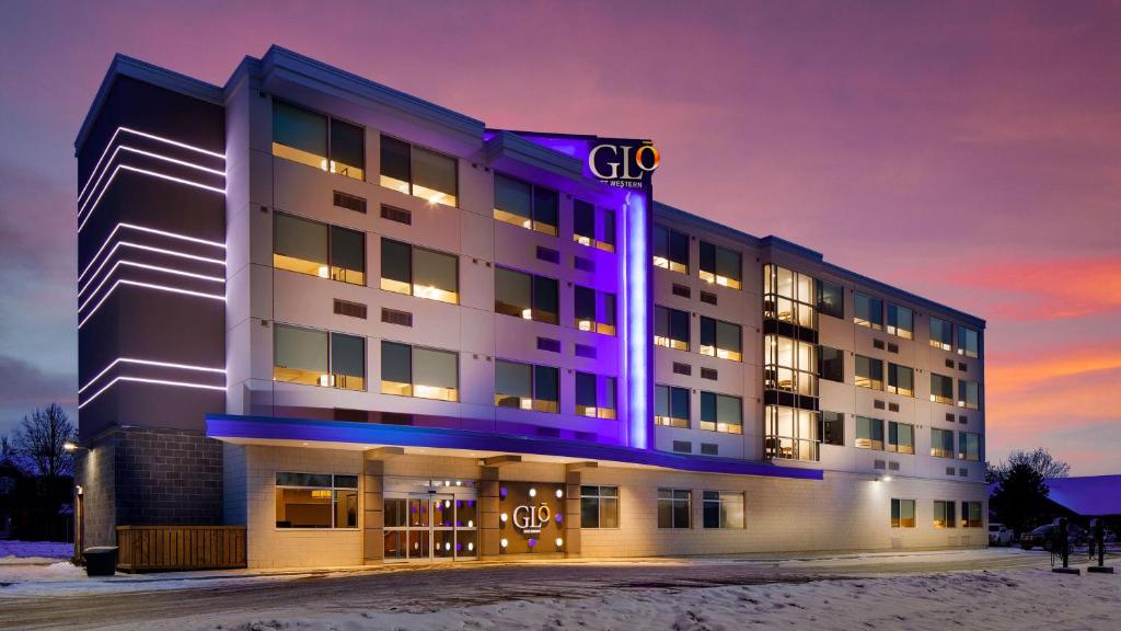 a large building with a purple light on it at GLō Best Western Kanata Ottawa West in Ottawa