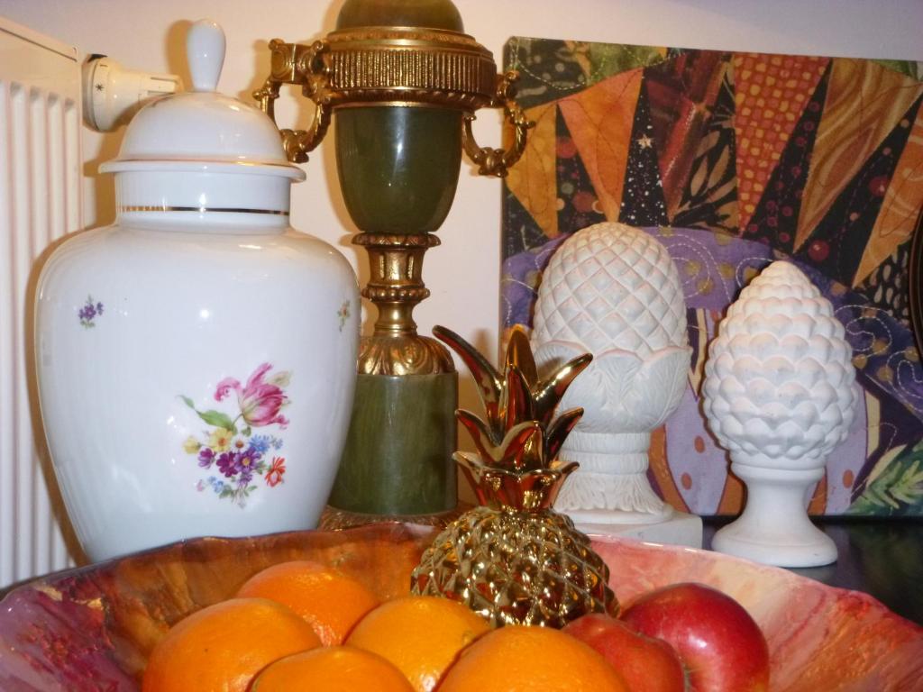 a bowl of oranges and other items on a table at Apartament City Center - 24 h contactless self check-in, no smoking, free bottled water, coffee and tea in Koszalin