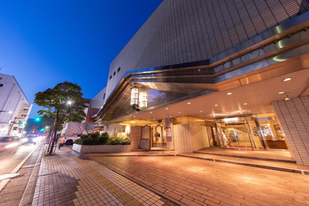 a building on a city street at night at Hotel Danrokan in Kofu