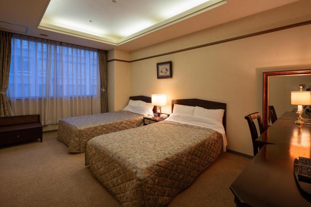 Postel nebo postele na pokoji v ubytování Hotel Danrokan