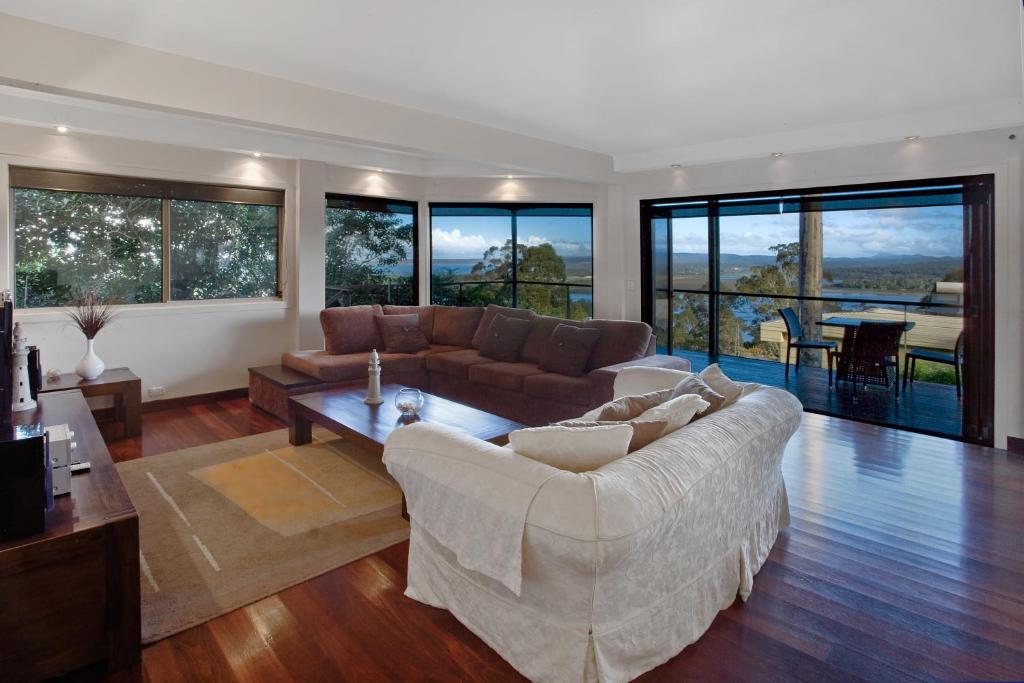 a living room with a couch and a table at Pure Indulgence in Merimbula