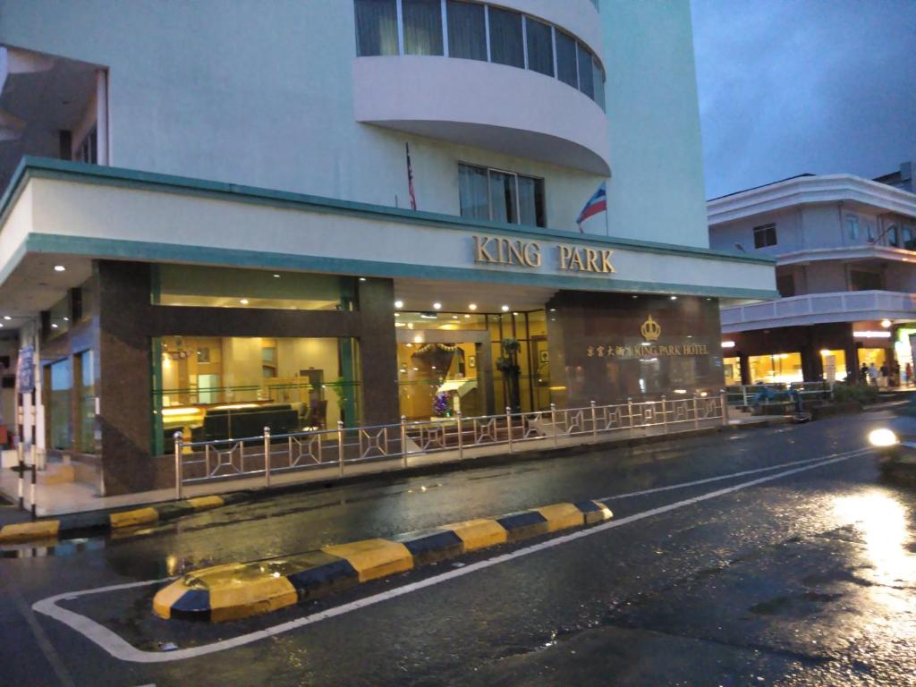 a building with a kings park on the side of a street at King Park Hotel Tawau in Tawau