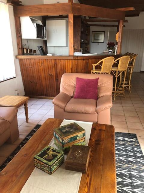 a living room with a couch and a table at The Vineyard View in Joostenberg Vlakte