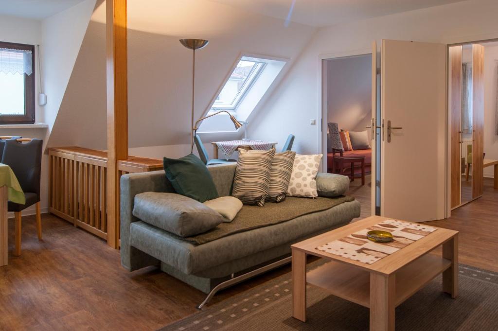 a living room with a couch and a table at Ferienwohnung Am Waldrand in Dresden