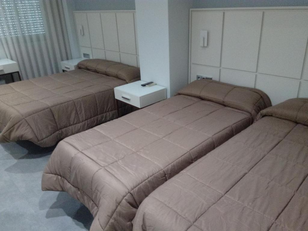 Postel nebo postele na pokoji v ubytování Hostal Loimar