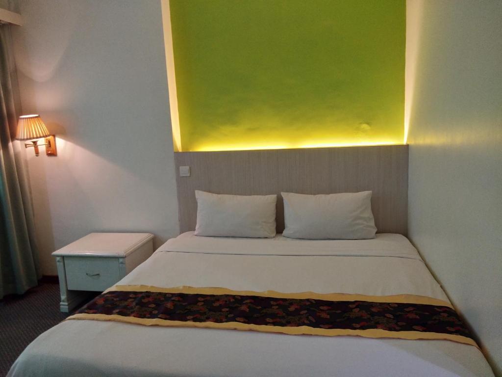 Postel nebo postele na pokoji v ubytování King Park Hotel Tawau