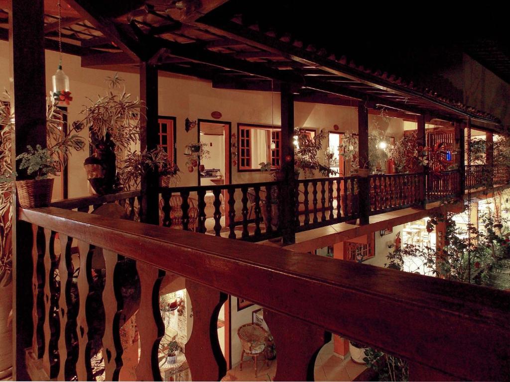 a balcony with a wooden railing in a house at Portal dos Borbas in Abraão