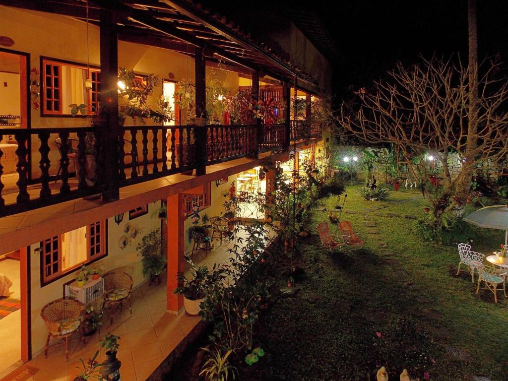 a balcony of a building with a garden at night at Portal dos Borbas in Abraão
