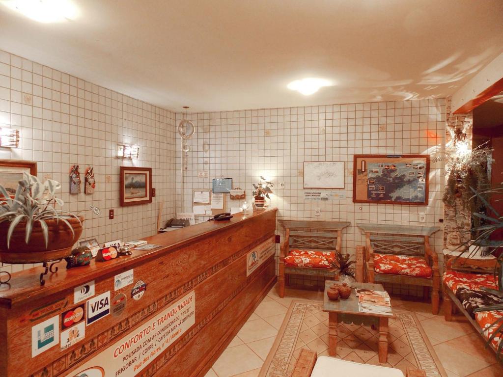 a shop with a counter and chairs in a room at Portal dos Borbas in Abraão
