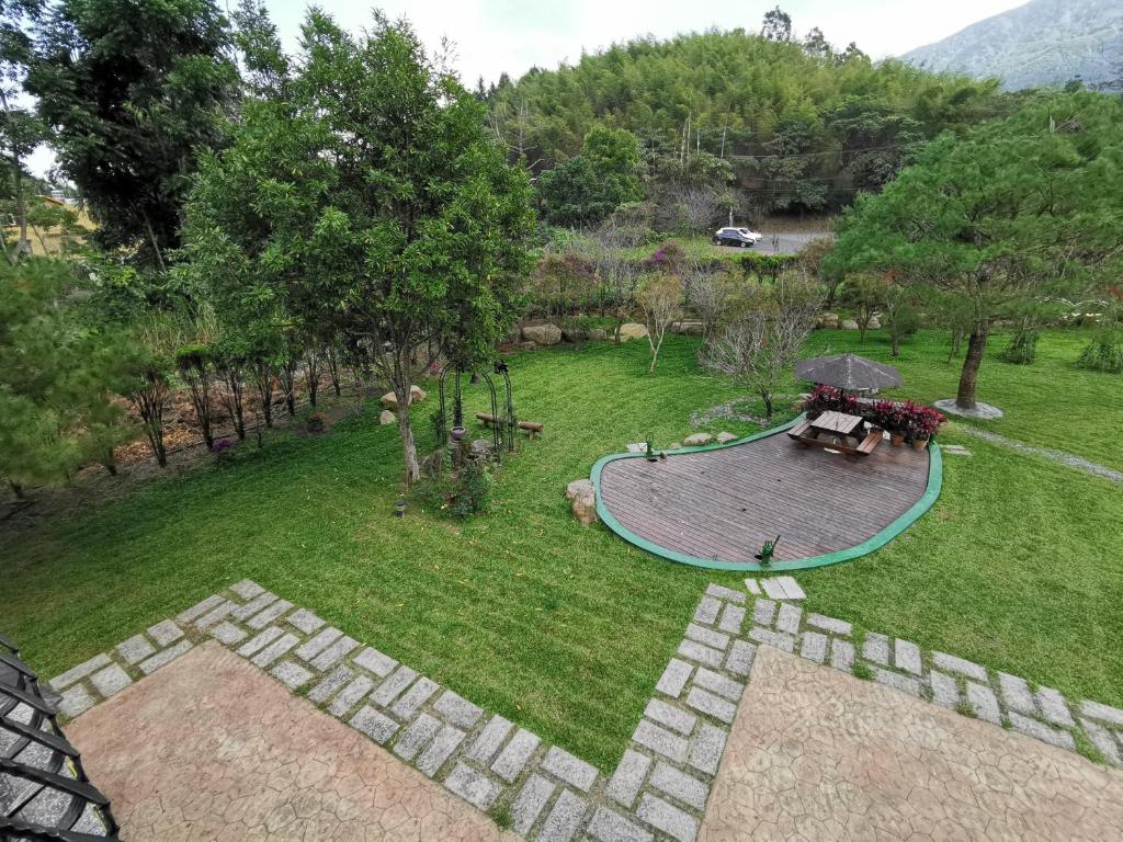 an aerial view of a garden with a patio and a table at Sitou Peach Villa B&amp;B in Lugu Lake