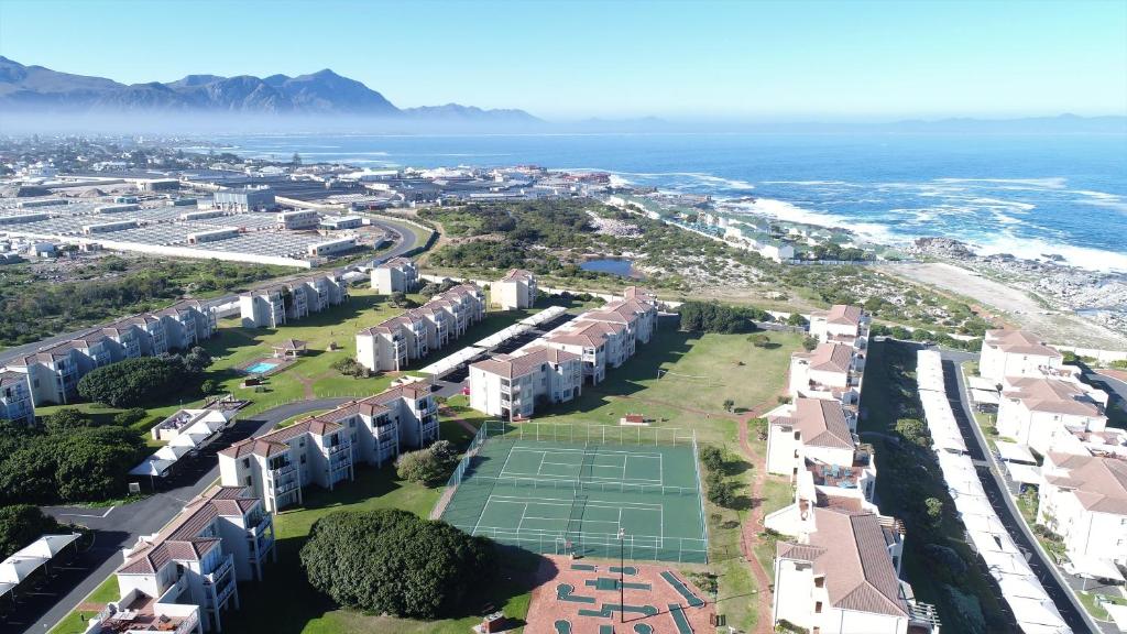 an aerial view of a city with a tennis court at Hermanus Beach Club in Hermanus