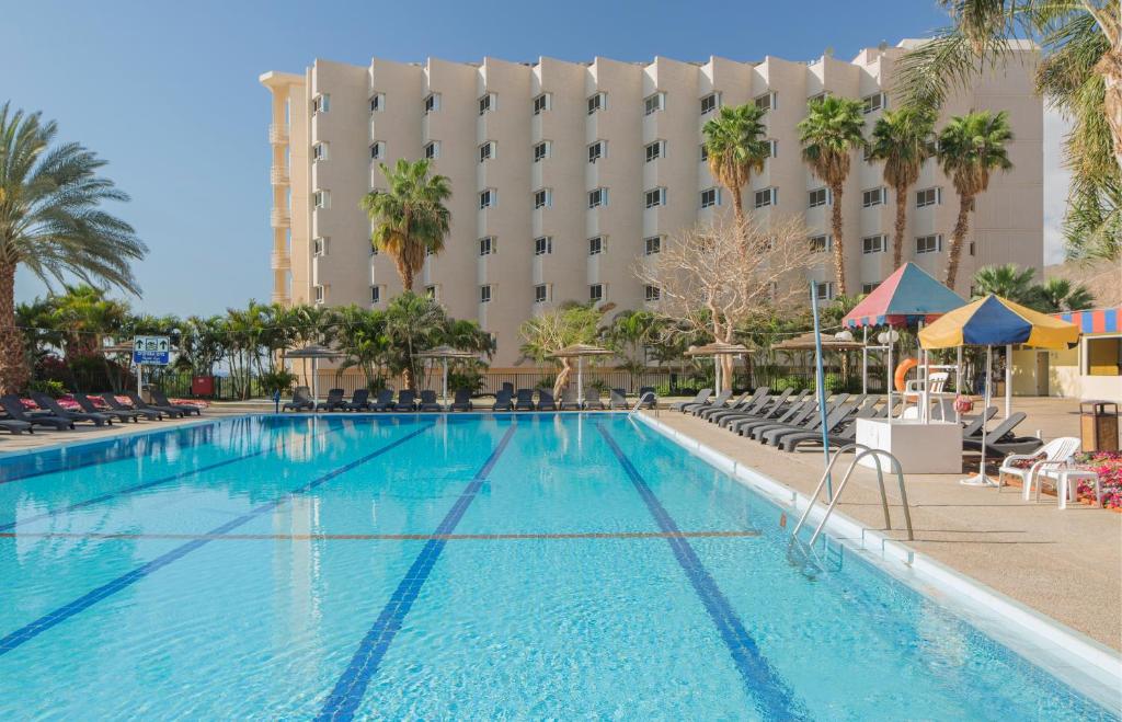 a large swimming pool in front of a hotel at Prima Music Hotel in Eilat