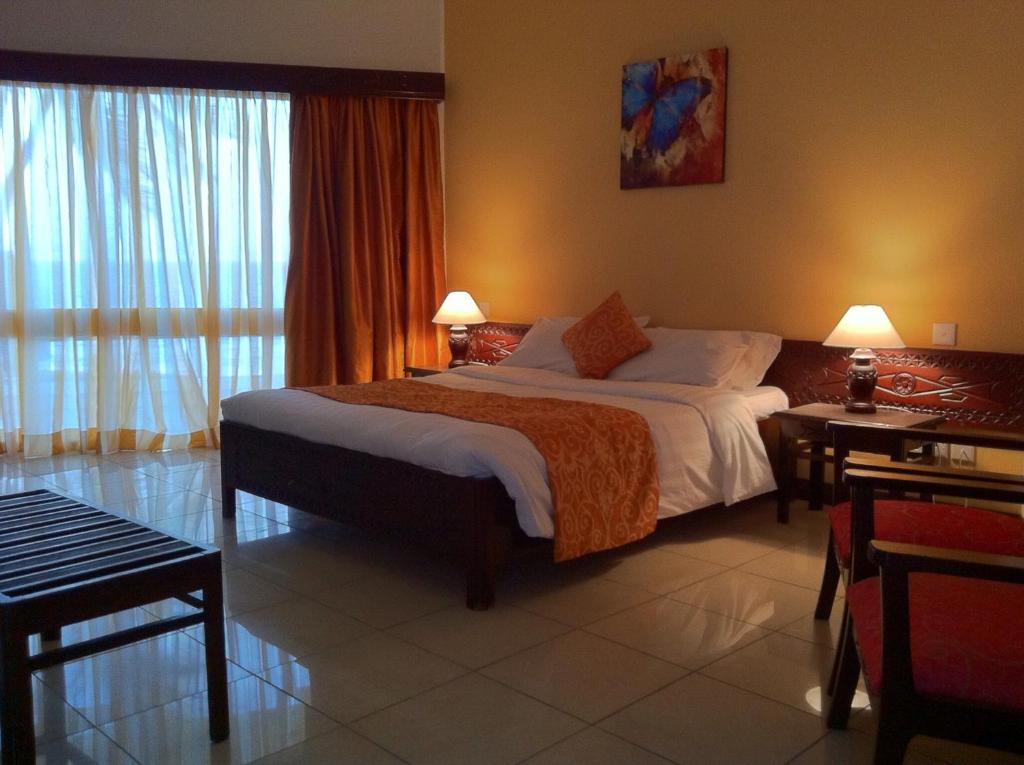 a hotel room with a large bed in a room at Kenya Bay Beach Hotel in Bamburi