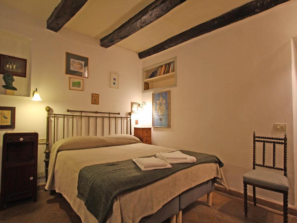 a bedroom with a bed and a chair at Terrace Apartment - Heart of Trastevere in Rome