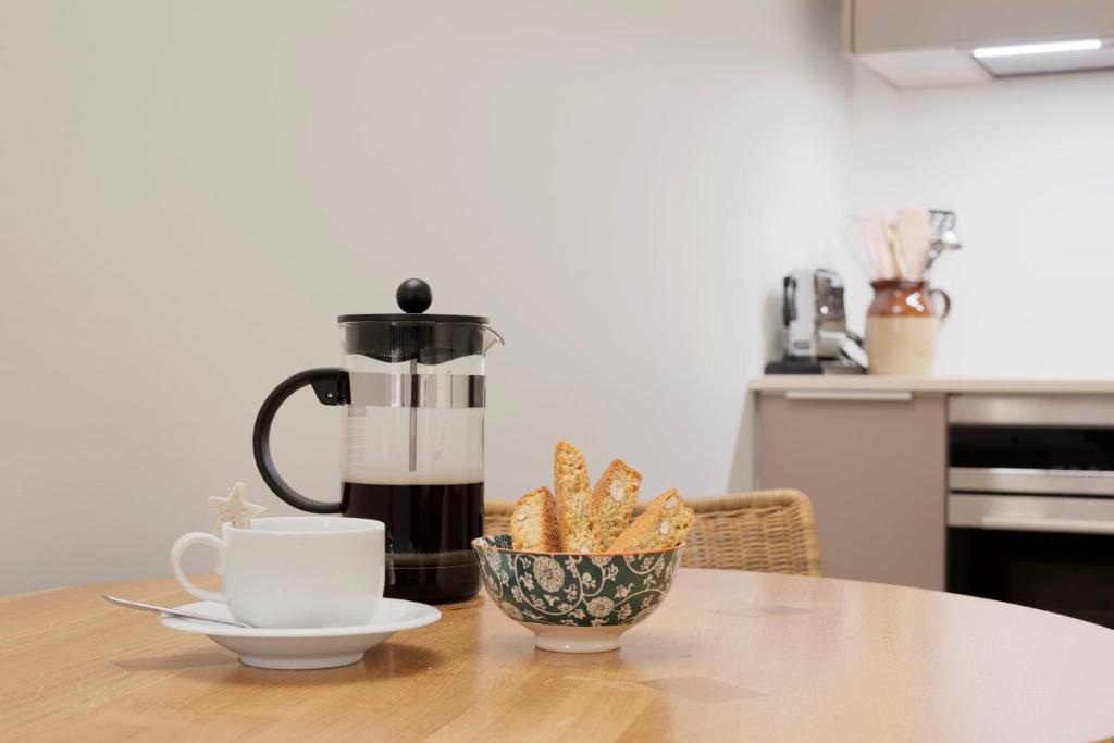 a cup of coffee and a bowl of food on a table at Haus-Ascot-Zermatt in Zermatt